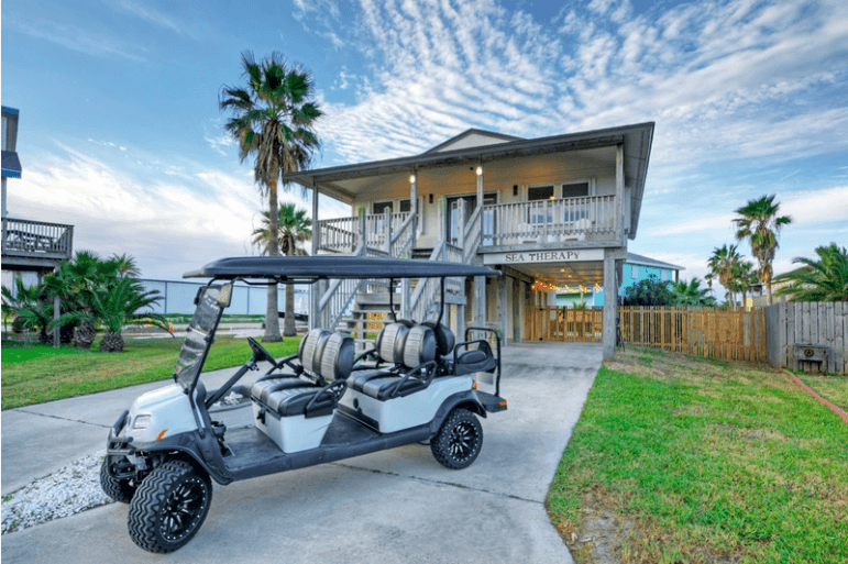 Four-seat golf cart parked by beach house, coastal exploration