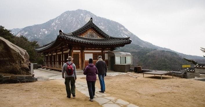 Historic temple courtyard with visitors under night sky