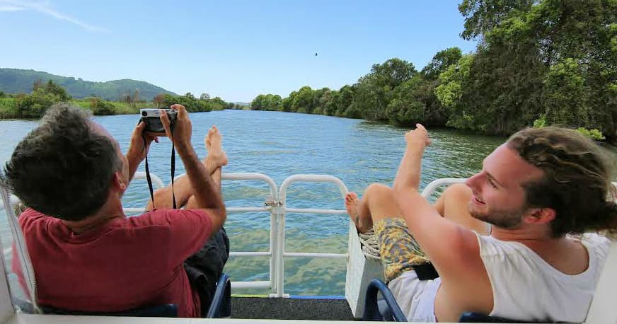 Relaxing river cruise passengers enjoying scenic river views