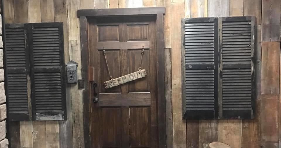 Weathered wood door with shutters in cozy escape room setting