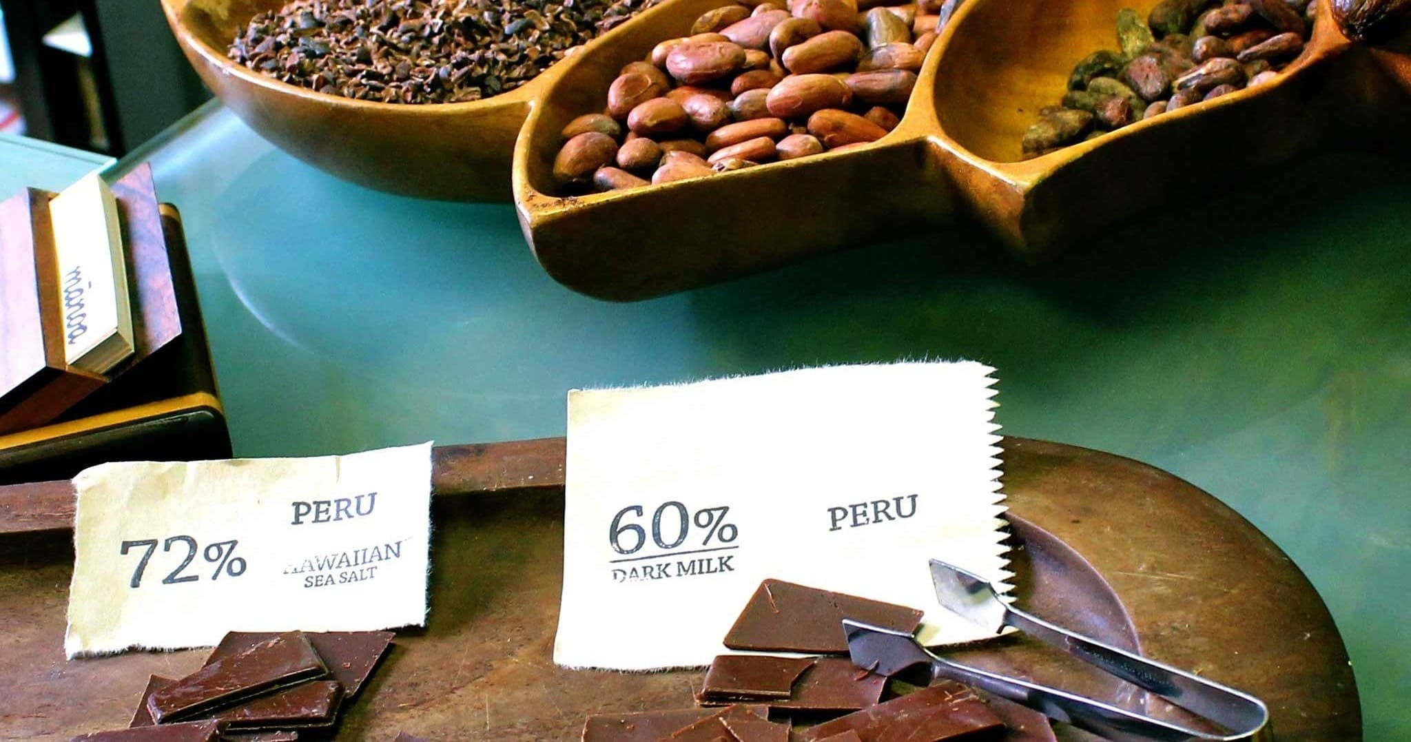 Chocolate samples and cacao percentage signs displayed at tasting counter