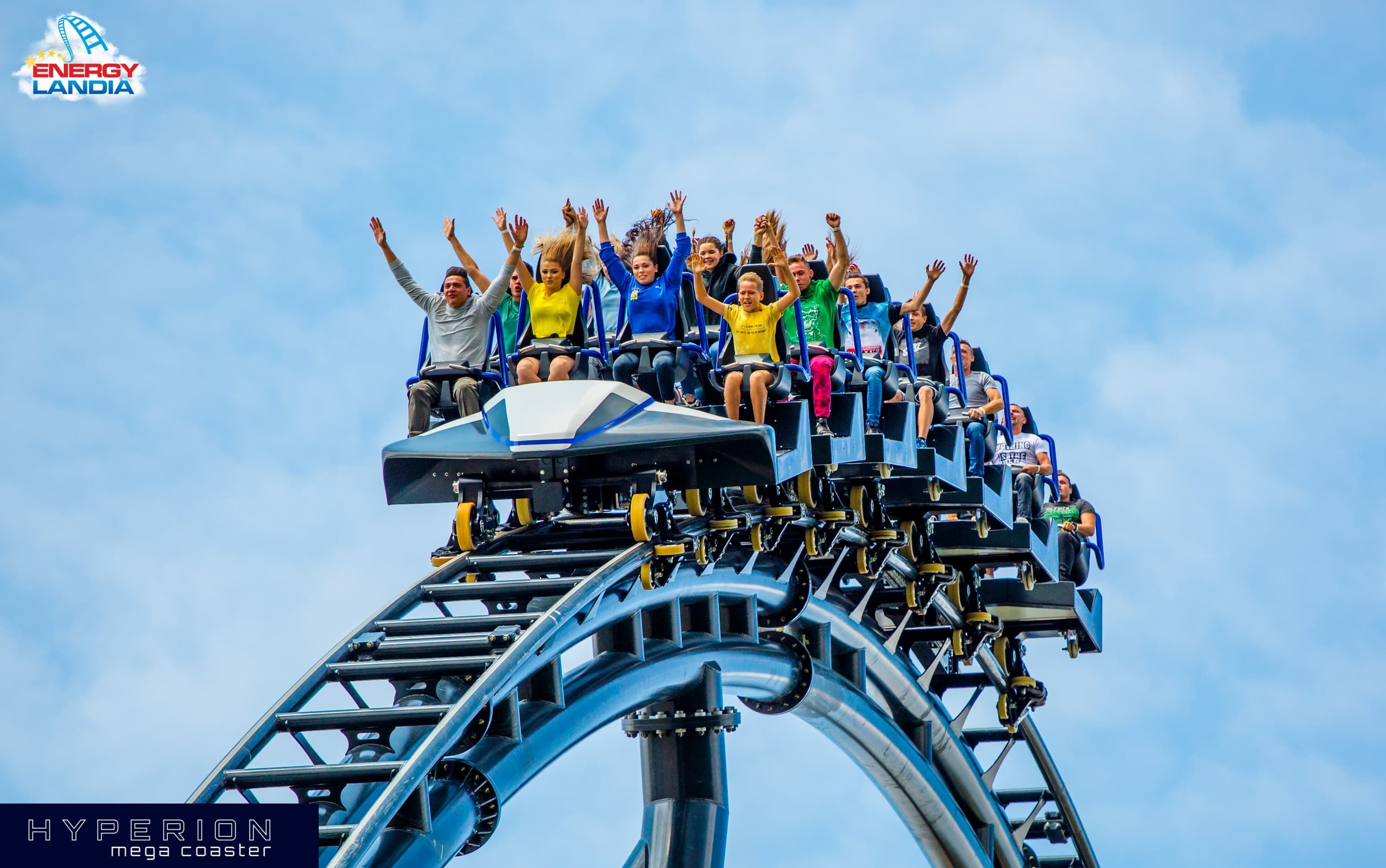 Riders screaming on outdoor roller coaster at amusement park