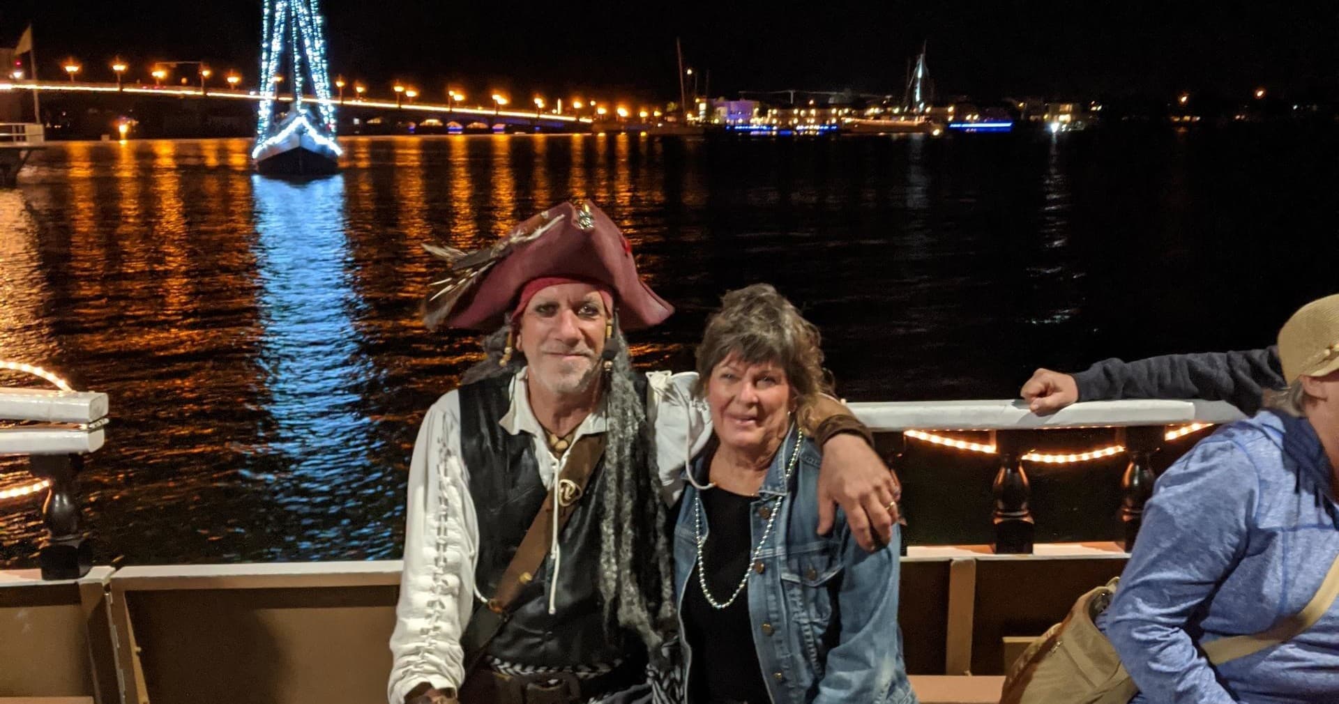 Couple enjoying nighttime pirate-themed harbor cruise in St. Augustine