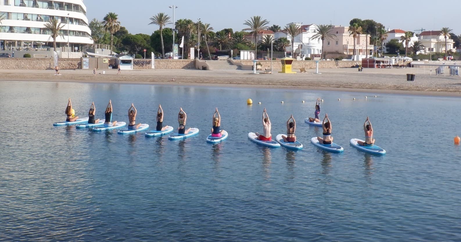 SUP Yoga Pilates in Sitges: 1-Hour Paddleboard Yoga & Pilates at Nootka Kayak