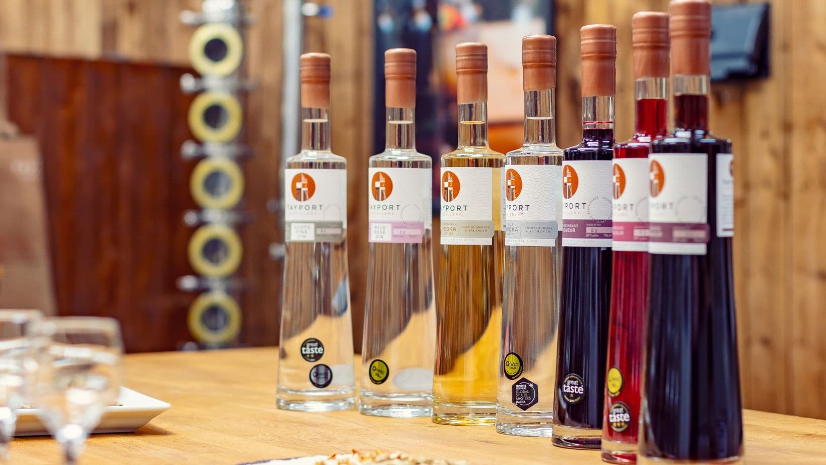 Tayport Distillery bottles displayed on wooden bar in tasting room
