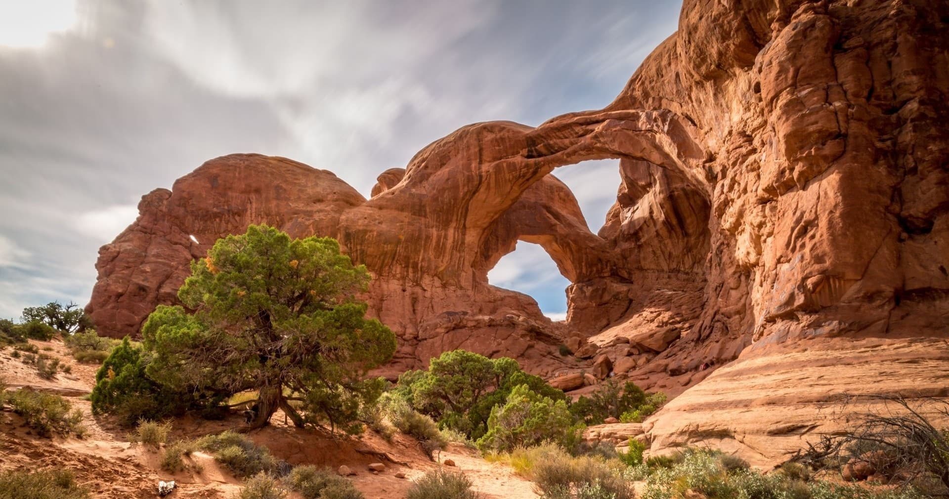 Scenic red rock arches in desert canyon for camping and hiking