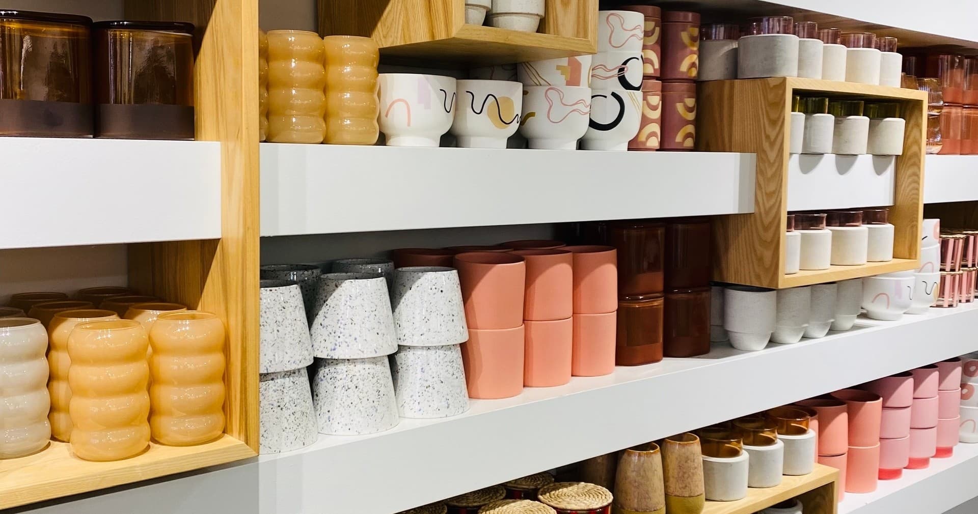 Shelves of scented candles and jars in boutique candle shop
