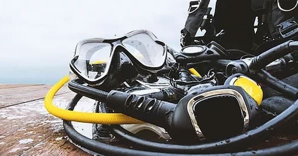 Scuba diving gear and regulators on boat deck before dive
