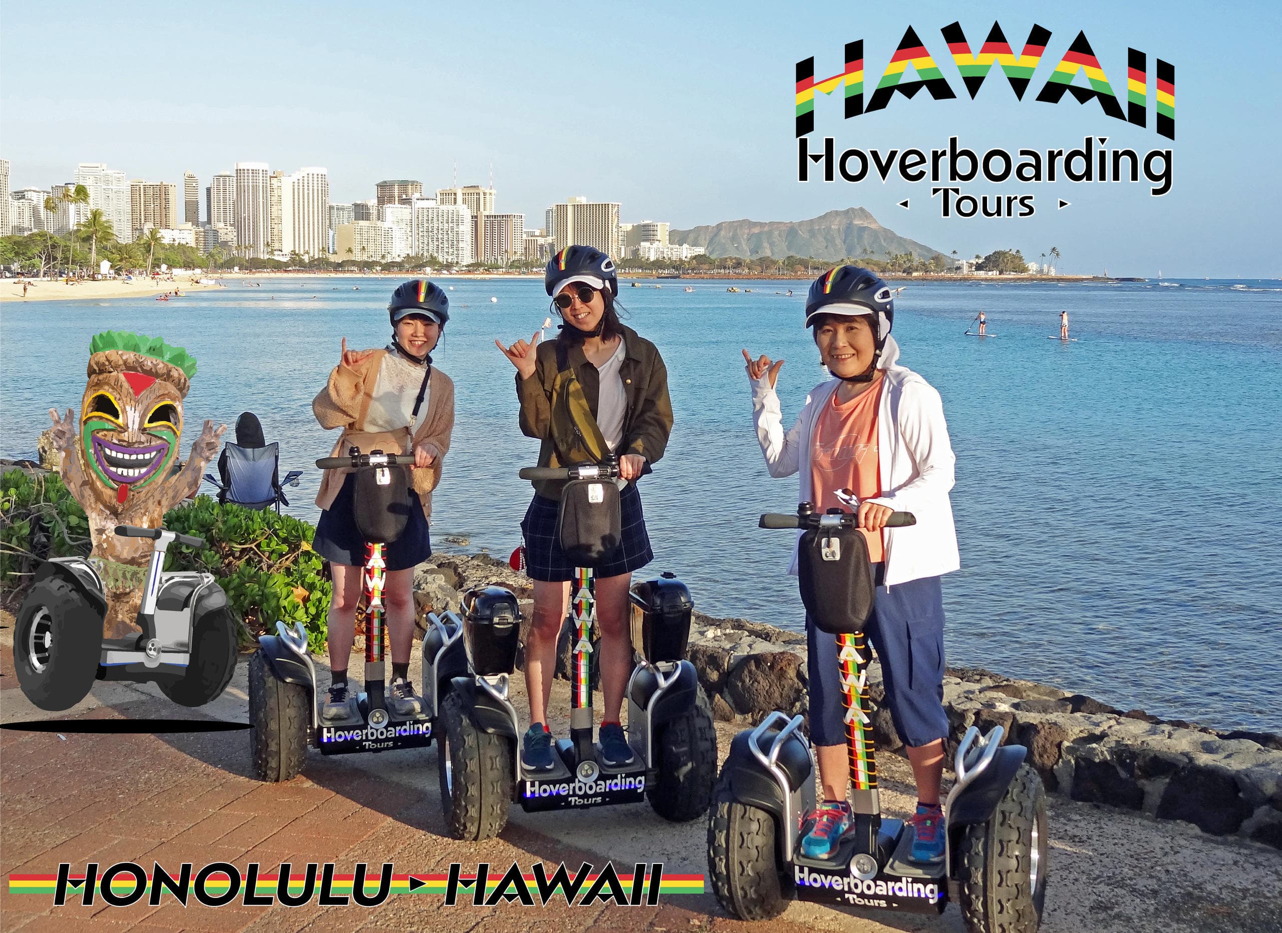 Guests hoverboarding along Waikiki shoreline with city skyline