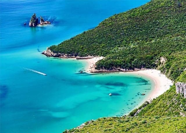 Secluded turquoise cove and pristine beach in Portugal
