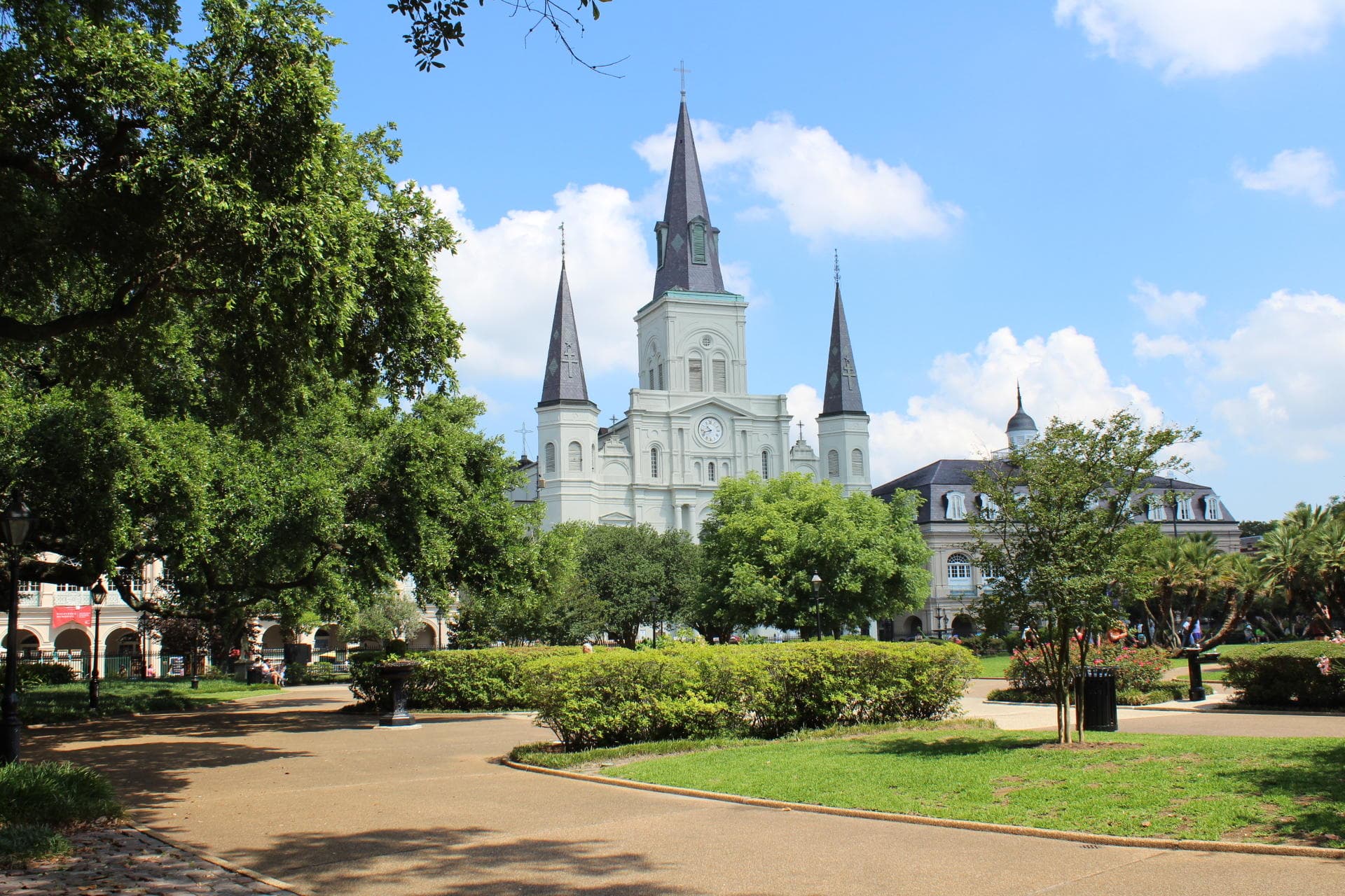Scenic park view with St. Louis Cathedral framed by oak trees in New Orleans
