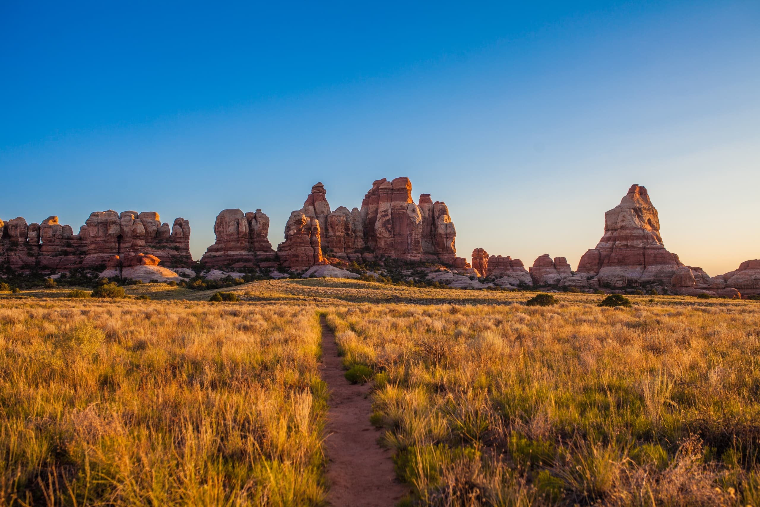 Golden light on sandstone formations across open desert plain