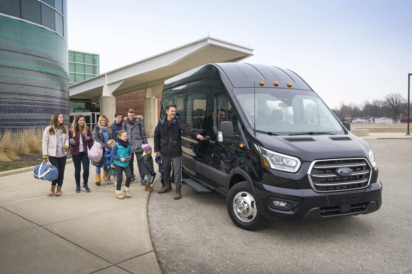 Shuttle van transporting travelers outside hotel and terminal