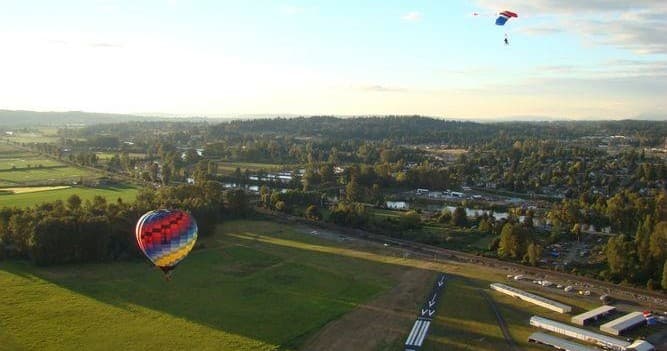 Hot air balloon drifting over Snohomish farmland at sunrise