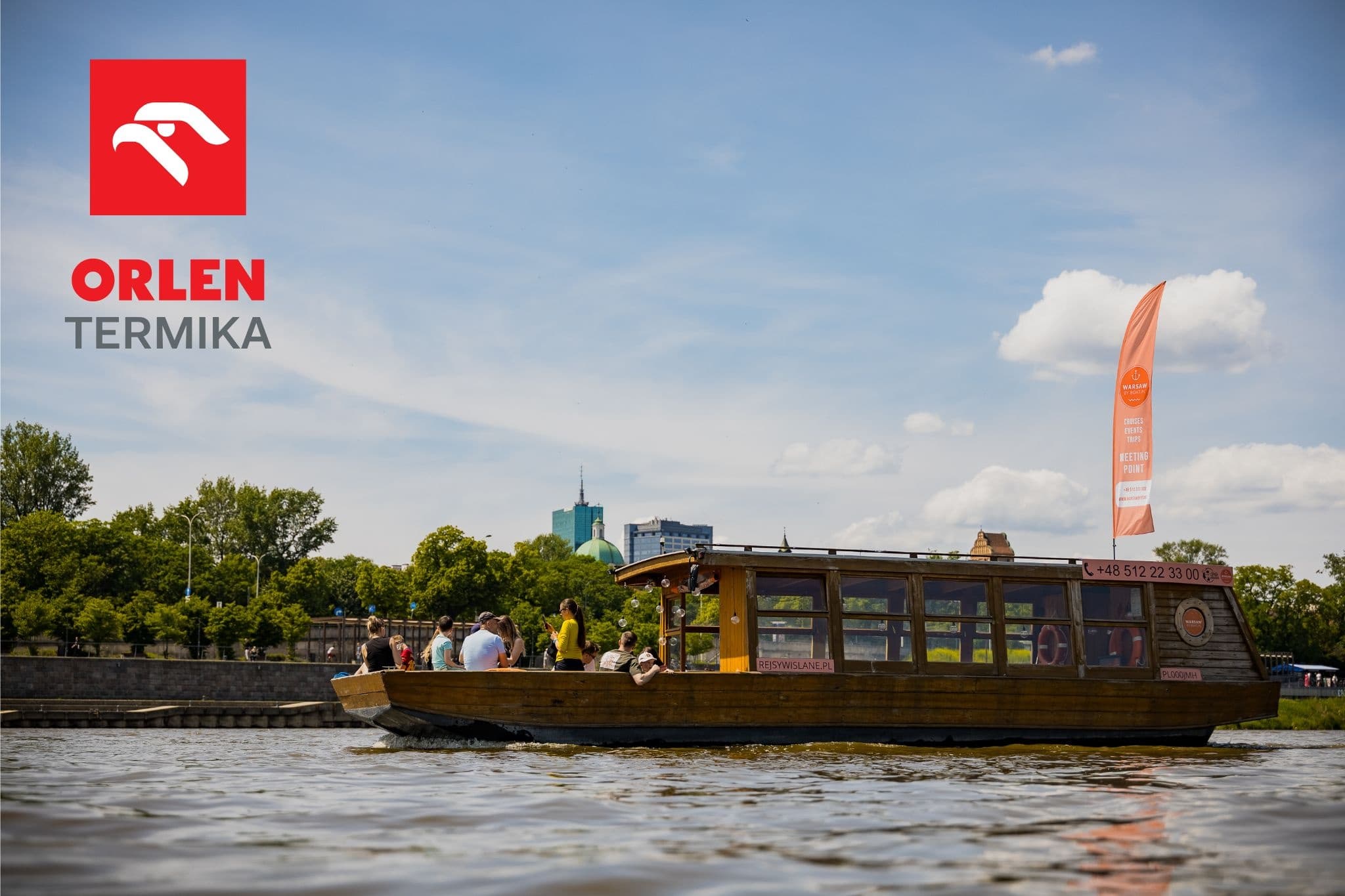 Daytime river tour boat on Vistula with city skyline view