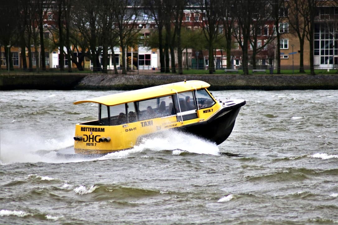 Yellow amphibious boat cruising through city's canal waters