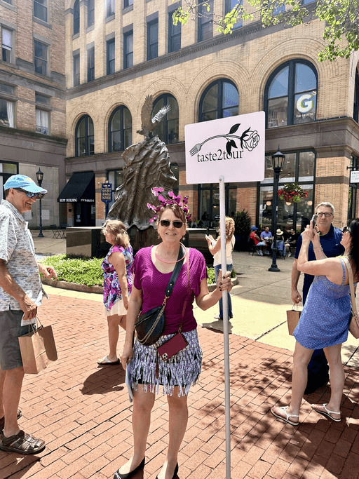 Guide leading a downtown food walking tour in city plaza