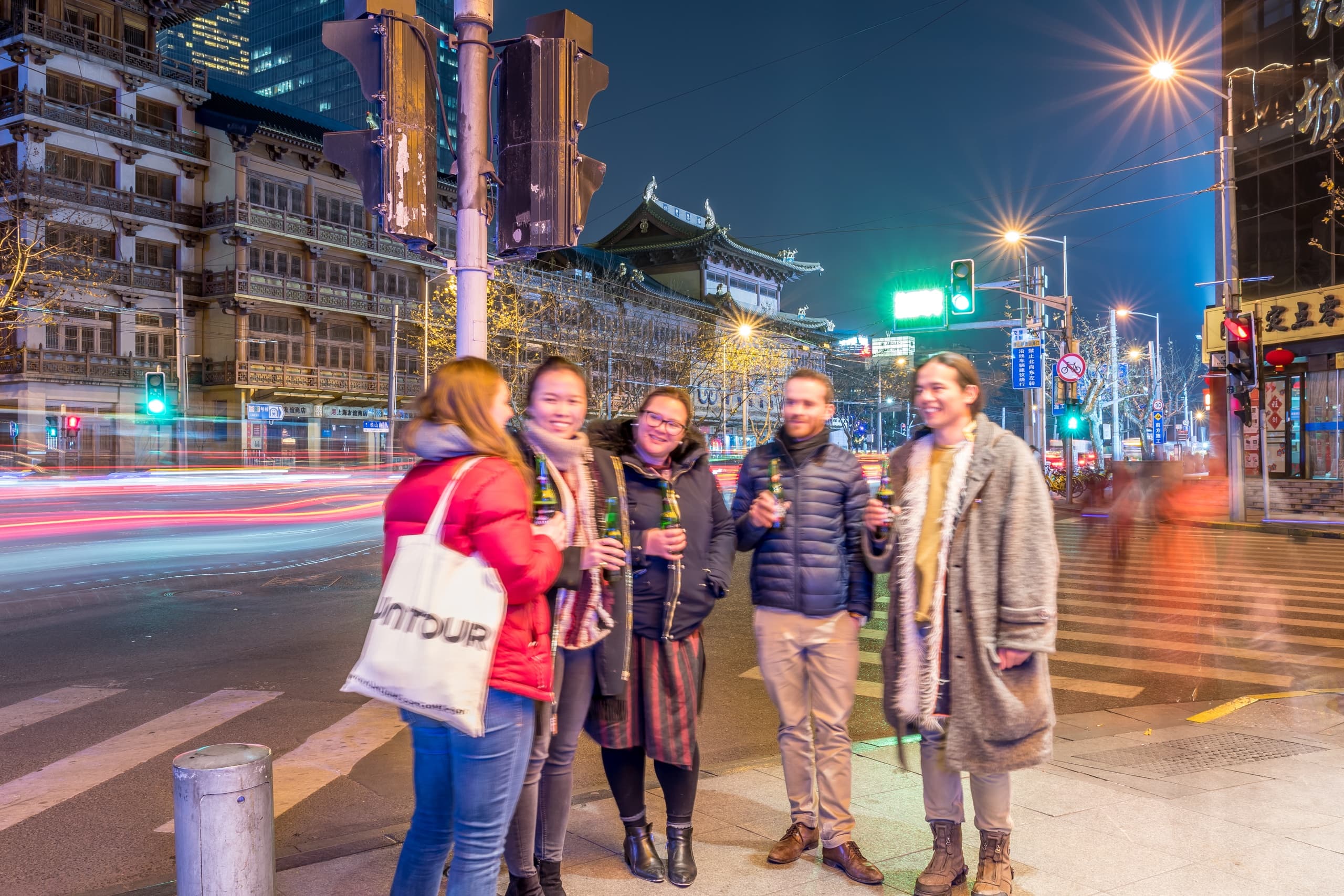 Group on nighttime city food walk in urban street tour