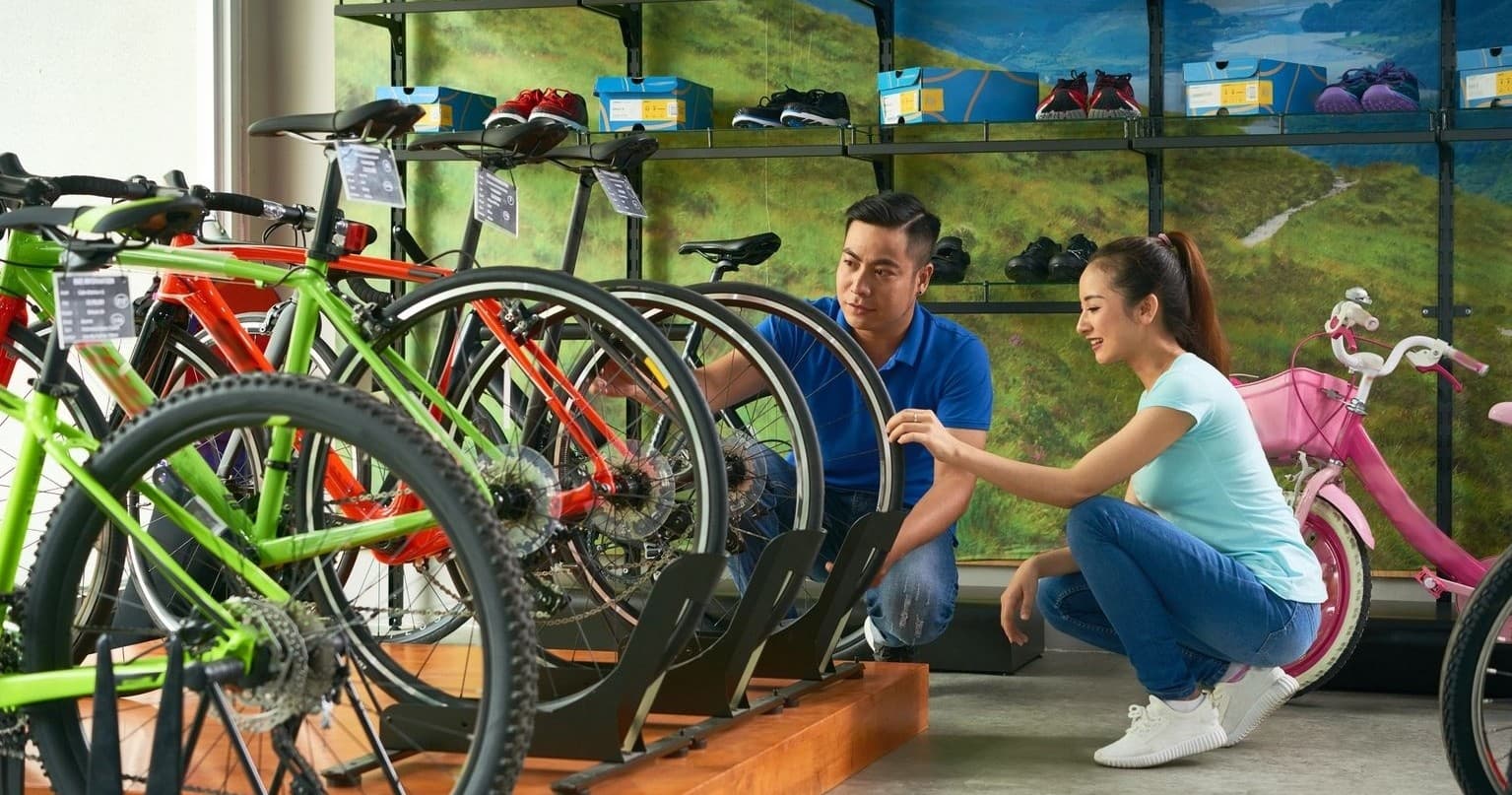 Bicycle display with customers comparing frames in showroom