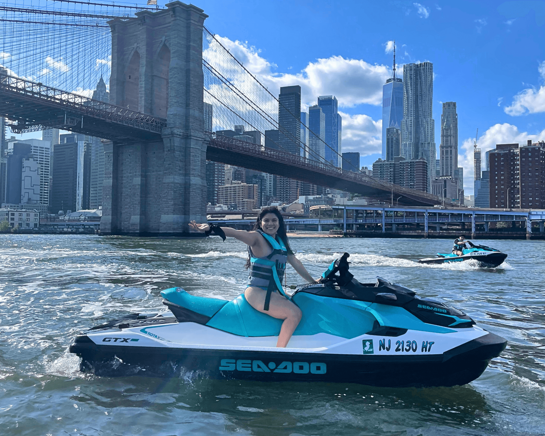 Jet ski rider by Brooklyn Bridge with Manhattan skyline view