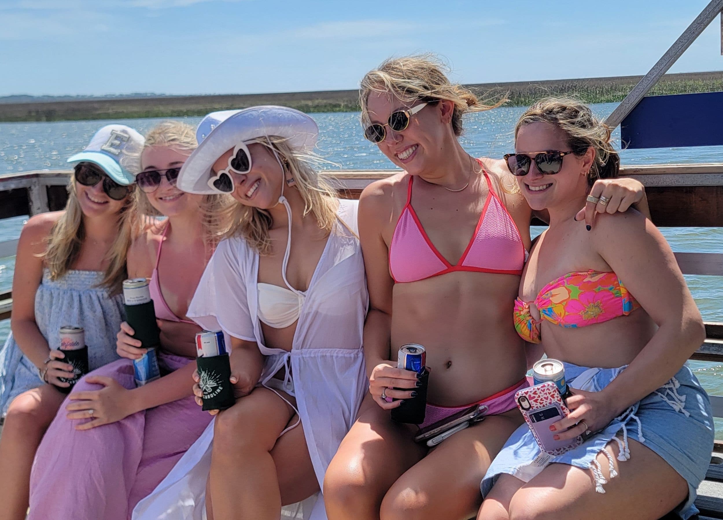 Friends relaxing on a party boat in sunny coastal waters near Tybee Island