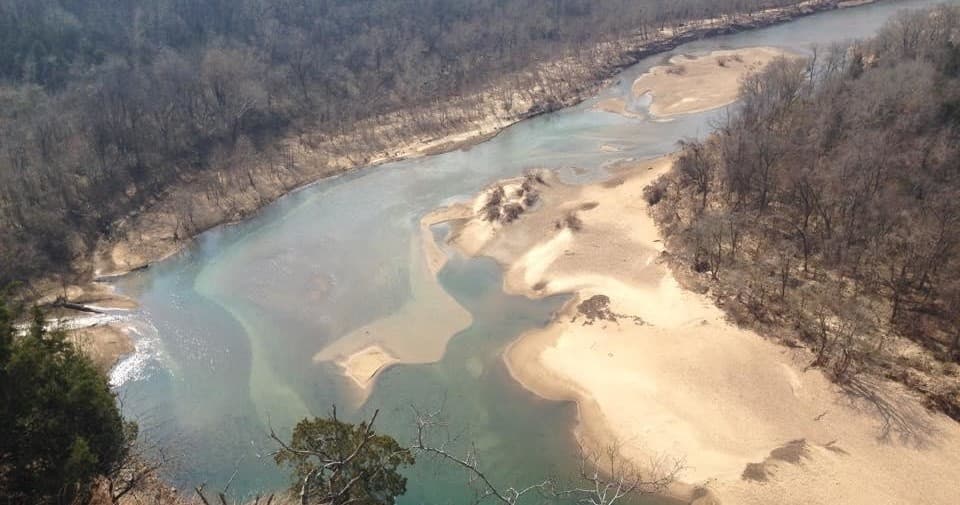 Aerial river sandbars and clear water in forested valley