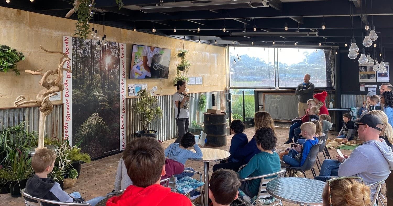 Audience at a wildlife talk in a covered outdoor venue