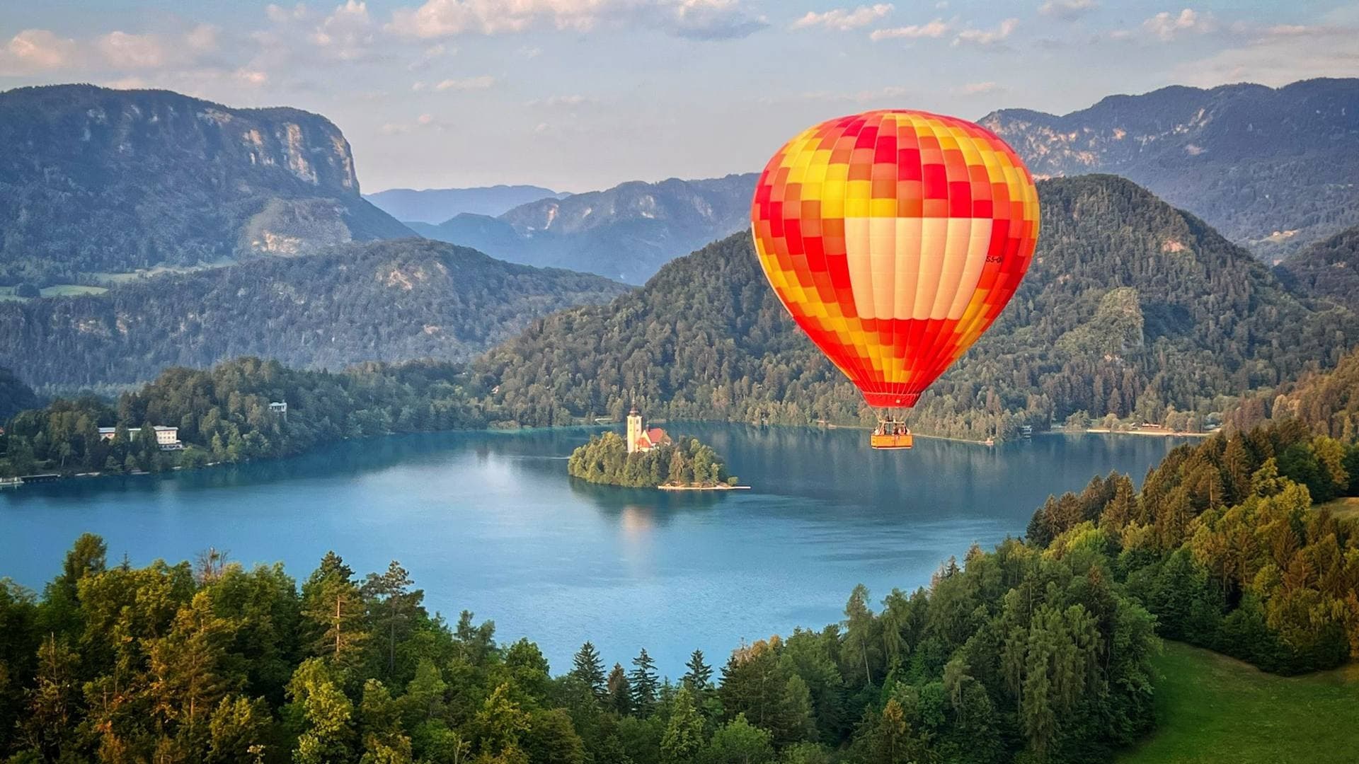 Hot air balloon over alpine lake near Ljubljana, scenic flight