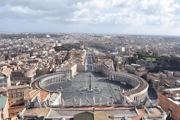 Panoramic Colosseum exterior with tourists on sunny day