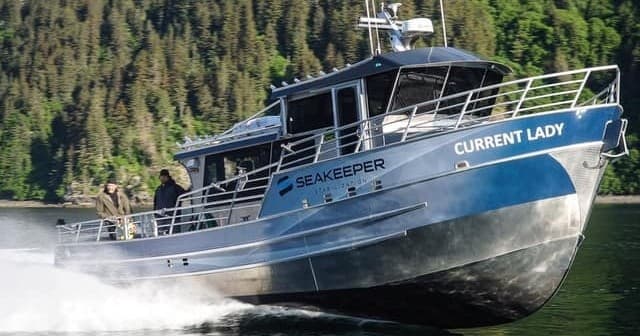 Close-up bow view of aluminum charter on calm coastal waters