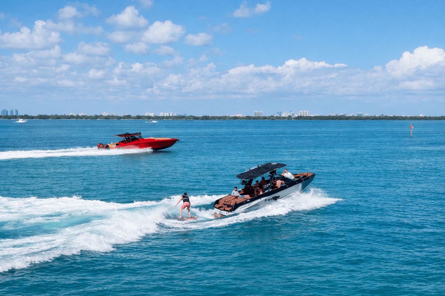 Speedboats carving wakes near Miami skyline on turquoise sea