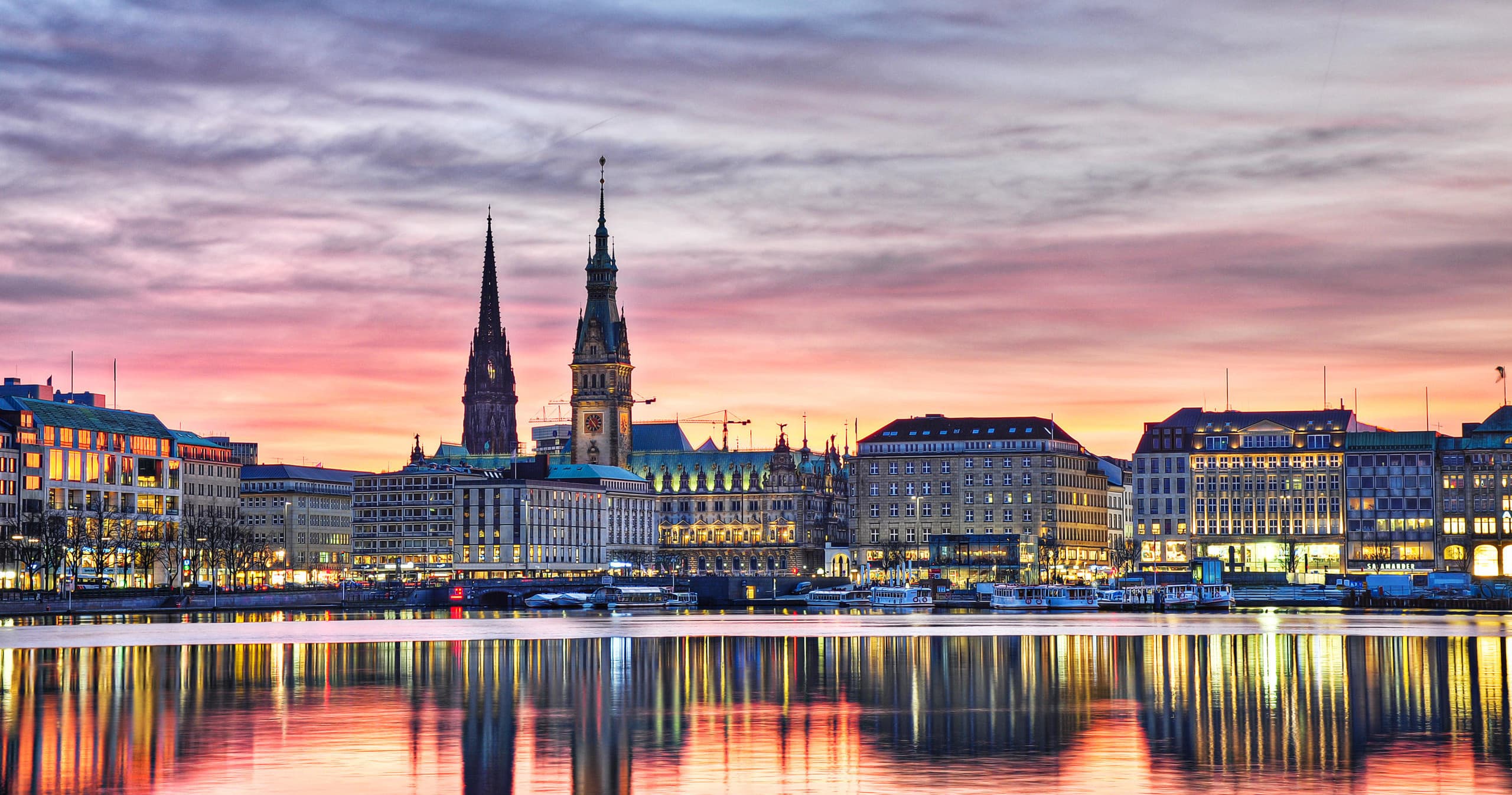 Panoramic Alster lake skyline at dusk in Hamburg city