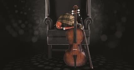 Vintage cello resting by armchair in dim room, atmospheric prop