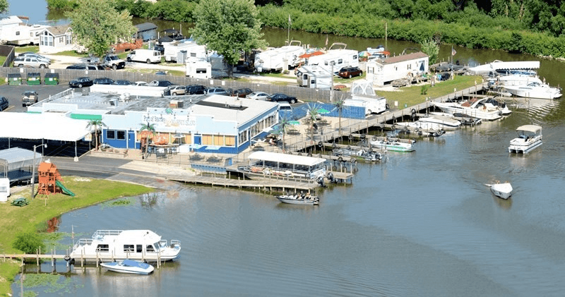 Marina boats and docks on riverfront harbor for leisure boating