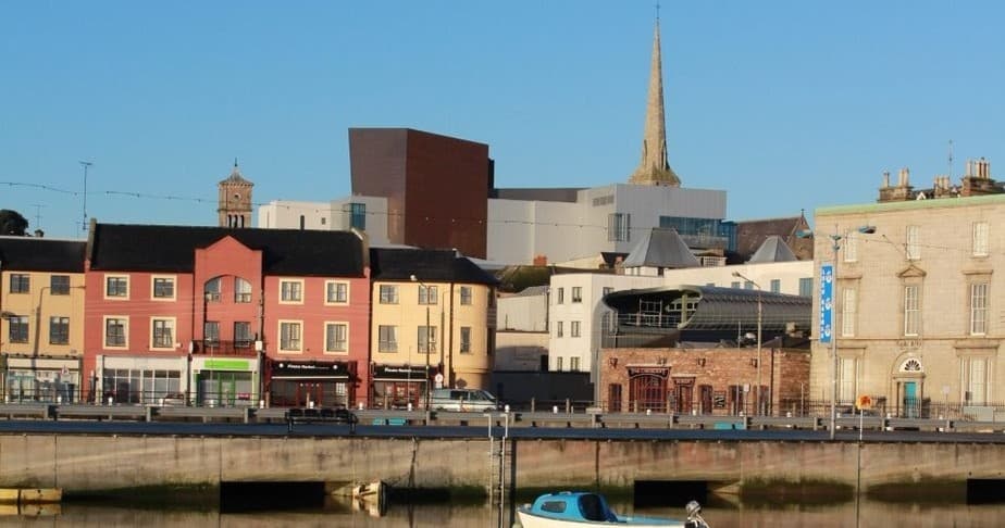 Riverside cityscape with colorful buildings and waterfront promenade