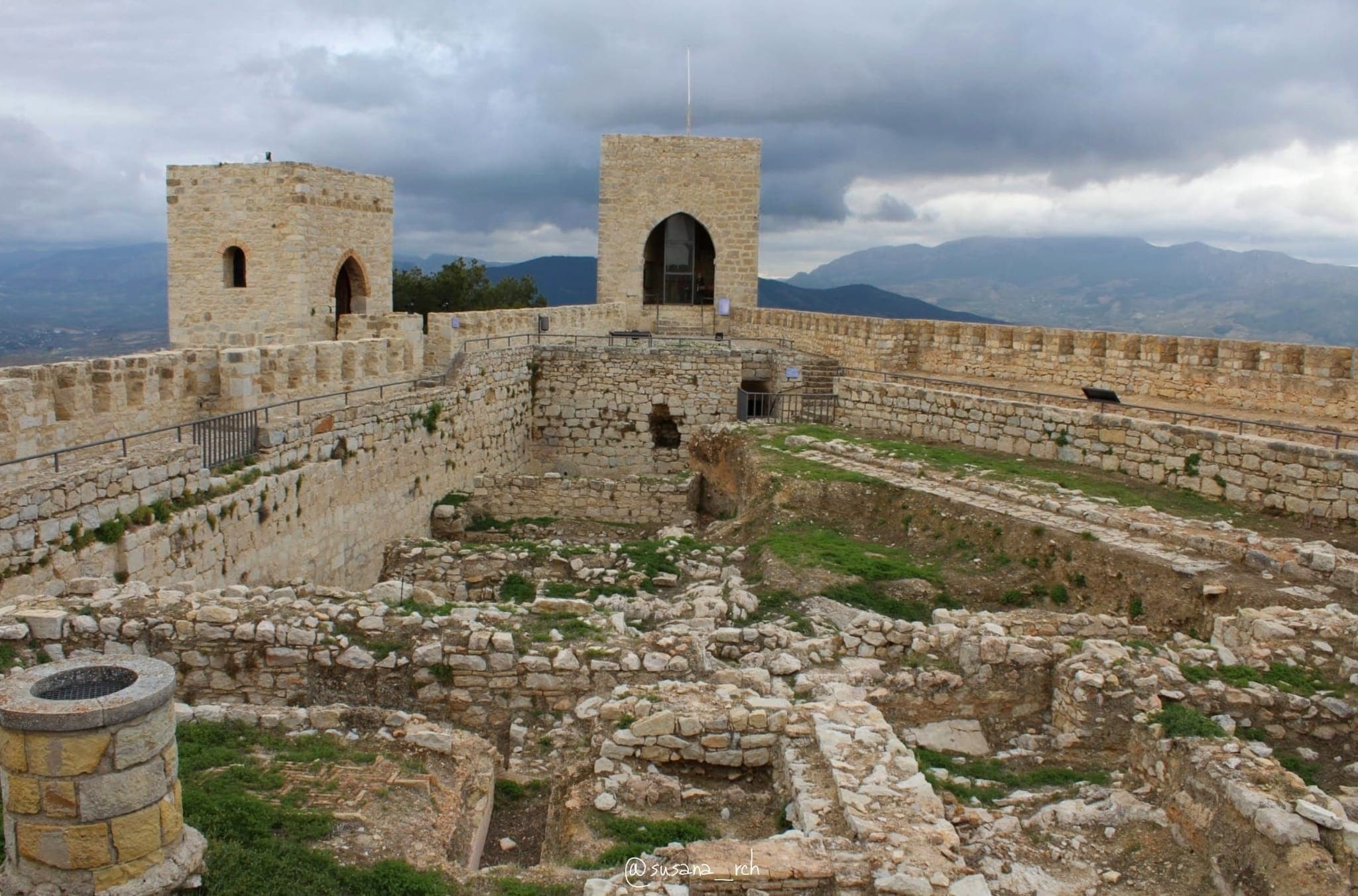 Ancient hilltop castle ruins and battlements overlooking landscape