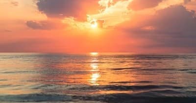 Sunset cruise over calm ocean at golden hour with vibrant sky