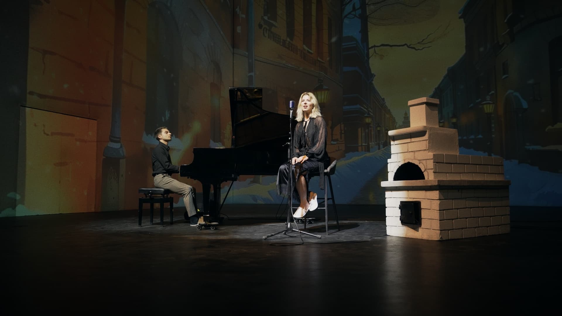 Singer and pianist on stage with city street projection backdrop