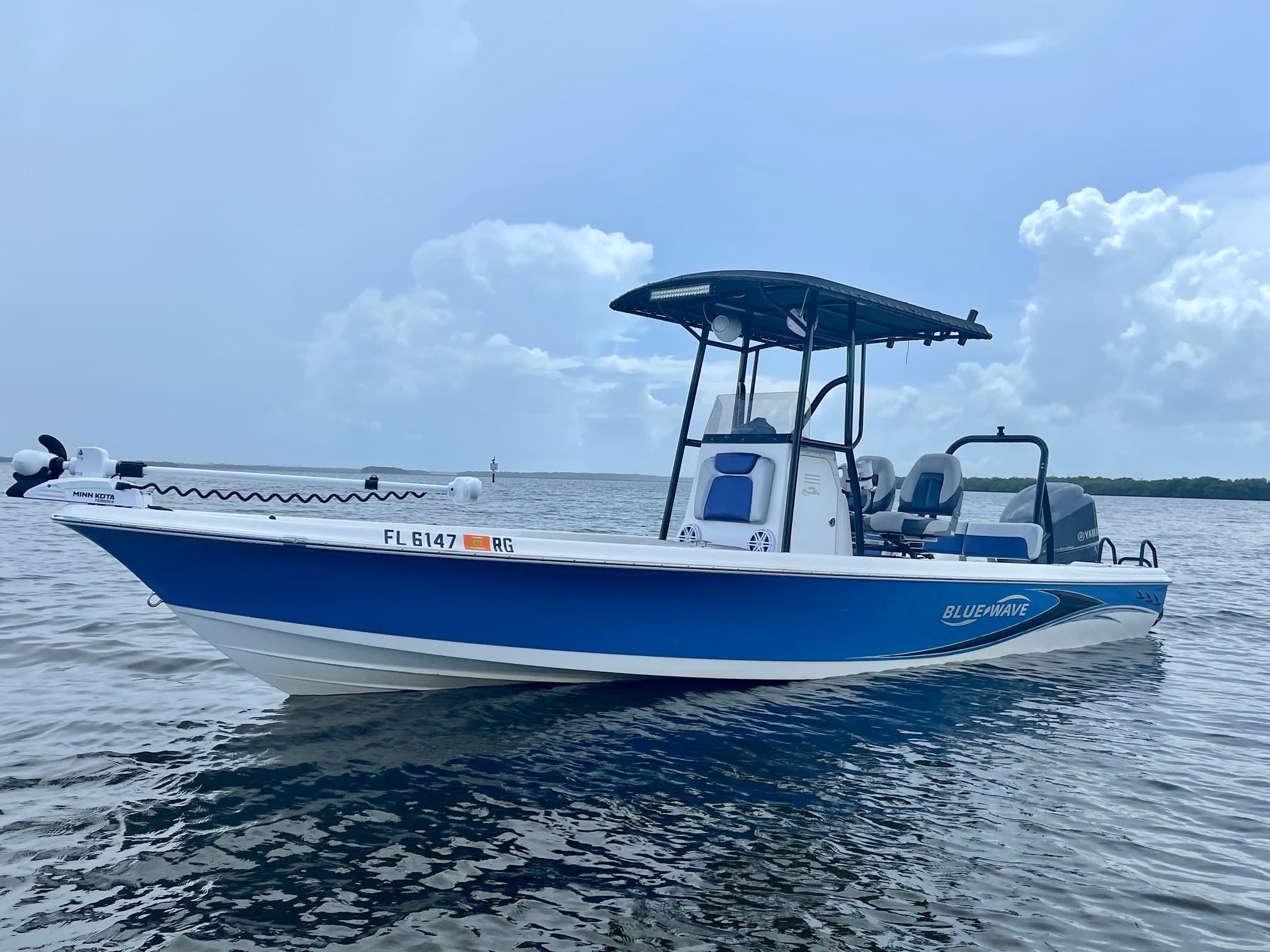 Blue skiff fishing boat on calm coastal waters near Florida coast