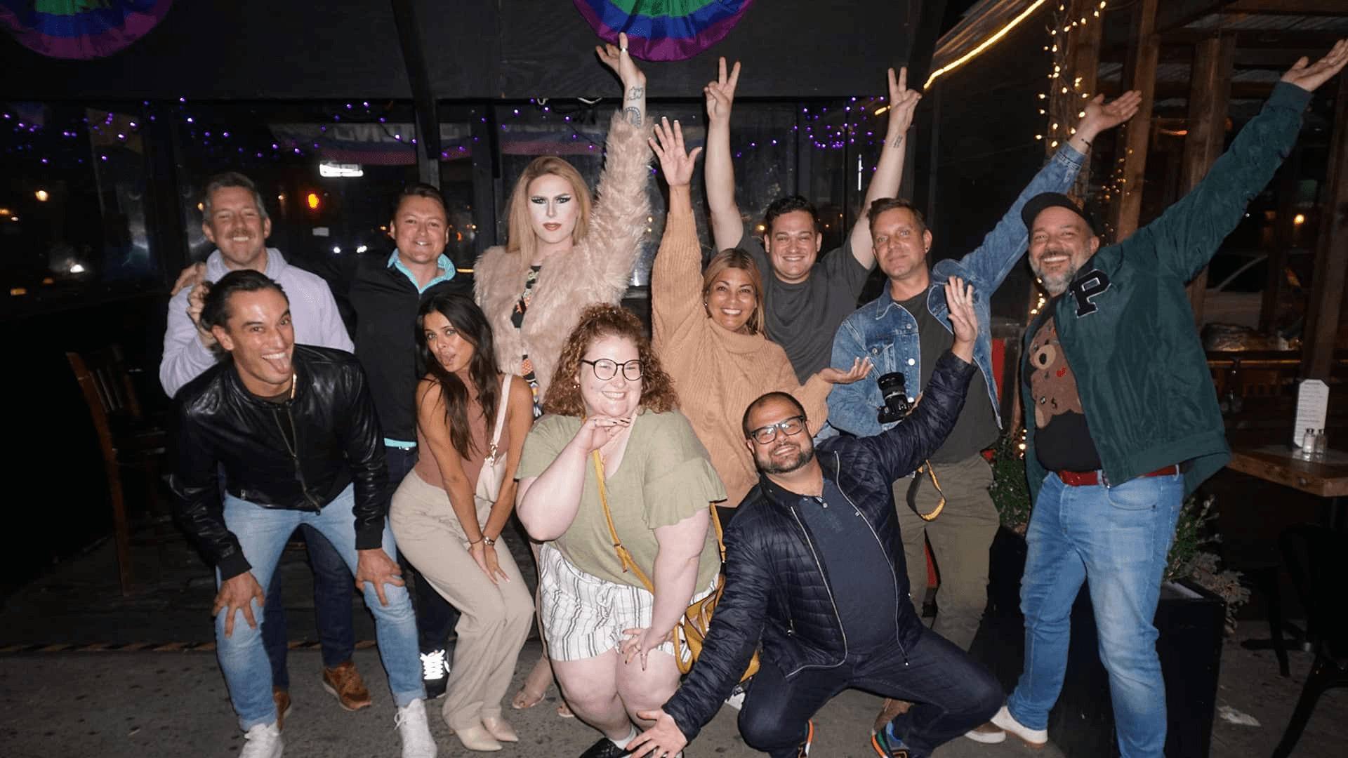 Friends celebrating on an outdoor city patio at night in NYC