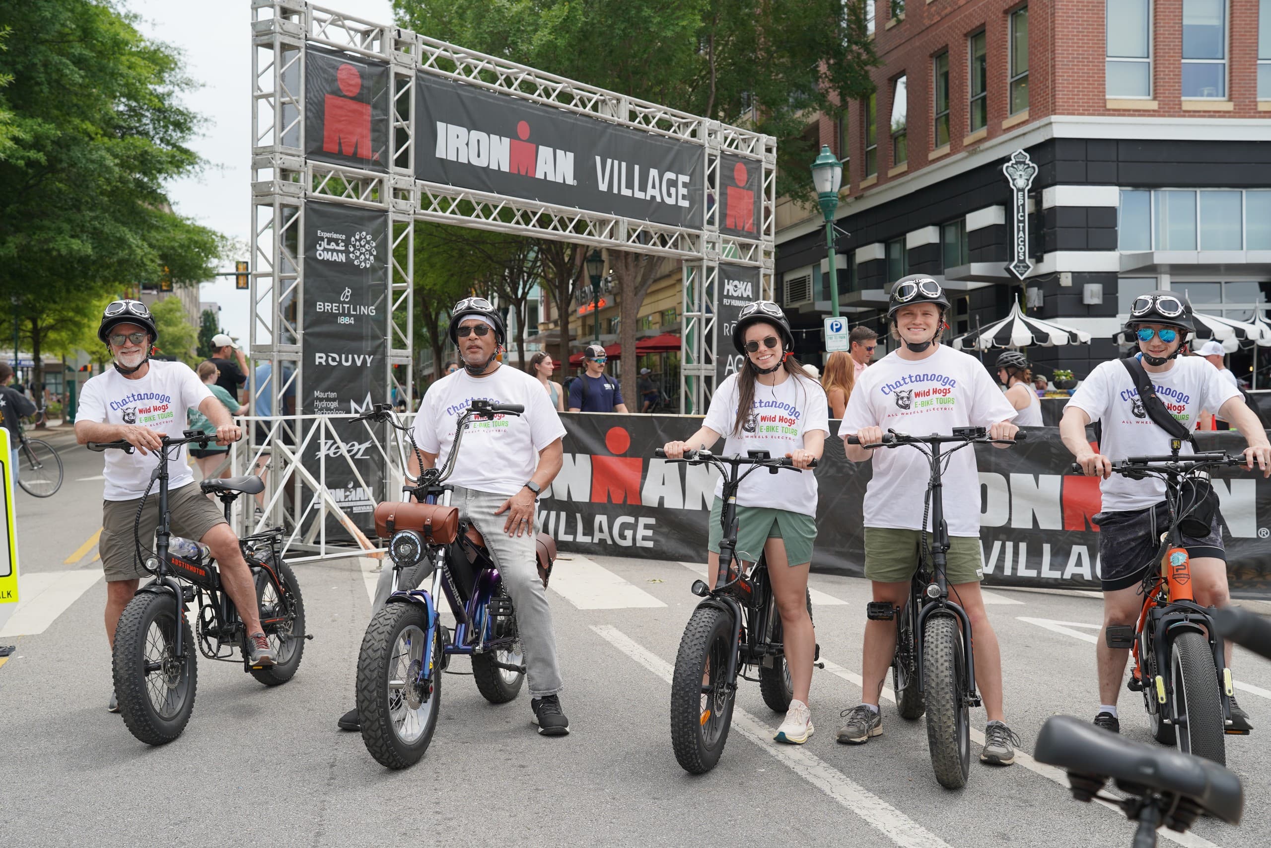 All-wheels e-bike group at outdoor event village by waterfront