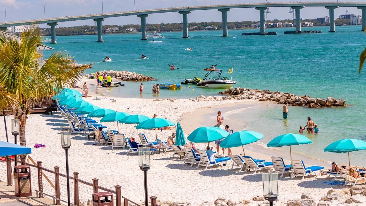 Family-friendly Clearwater Beach with umbrellas and calm shallow bay waters