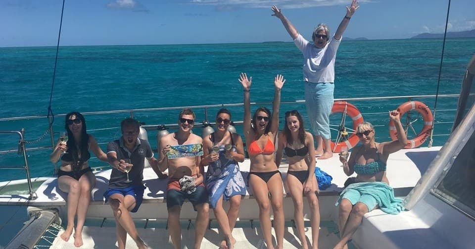 Group enjoying catamaran reef cruise with ocean views and sun