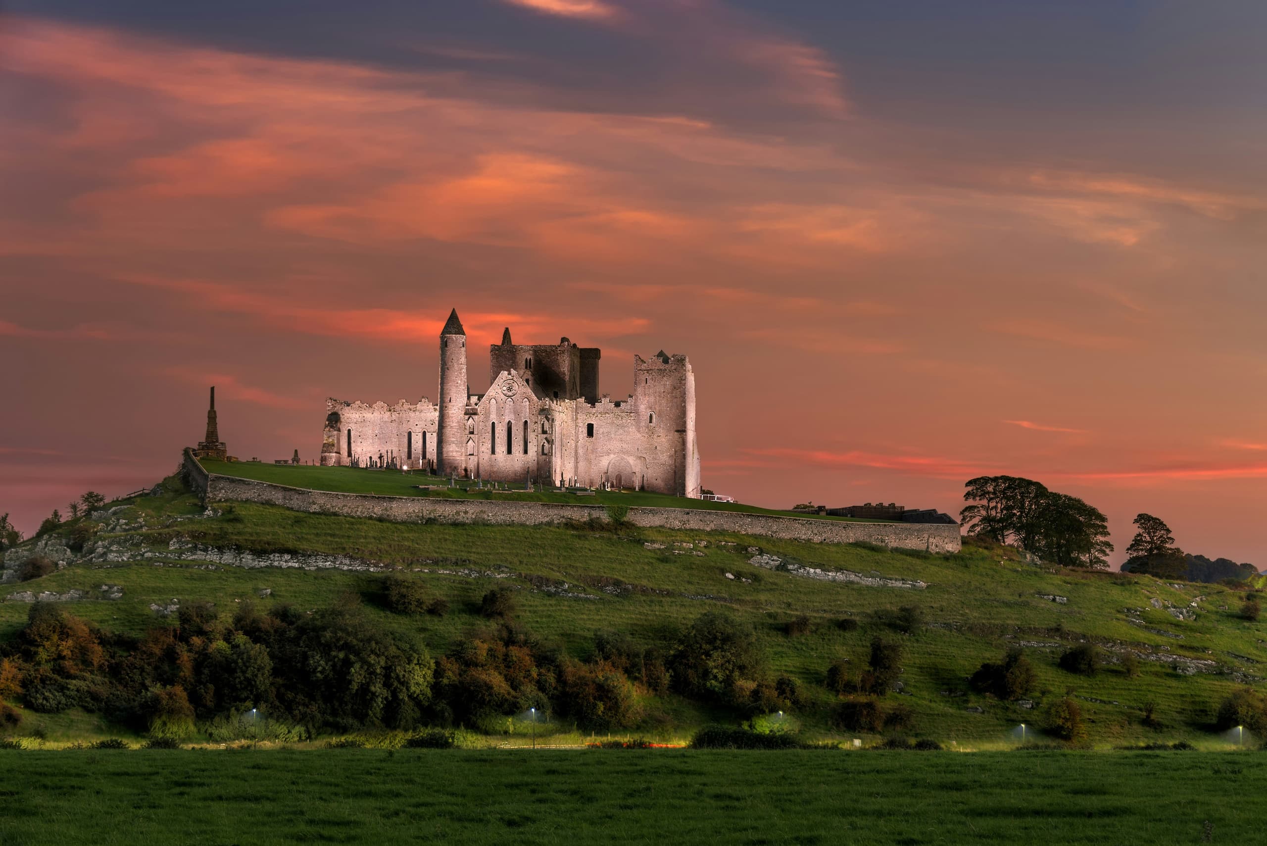 Hilltop medieval castle at sunset offering dramatic landscape views