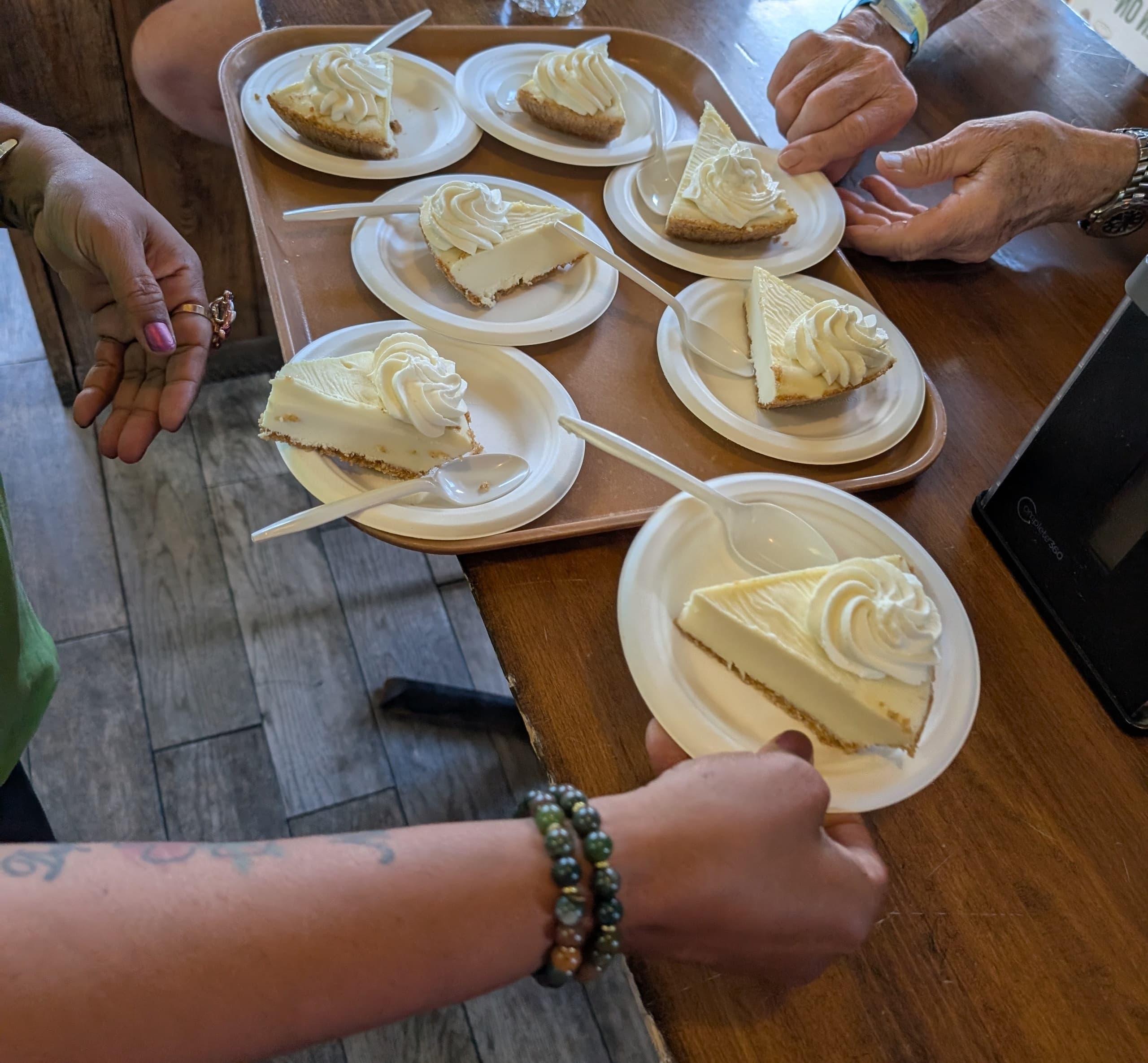 Indoor dessert serving of key lime pie slices on plates at counter