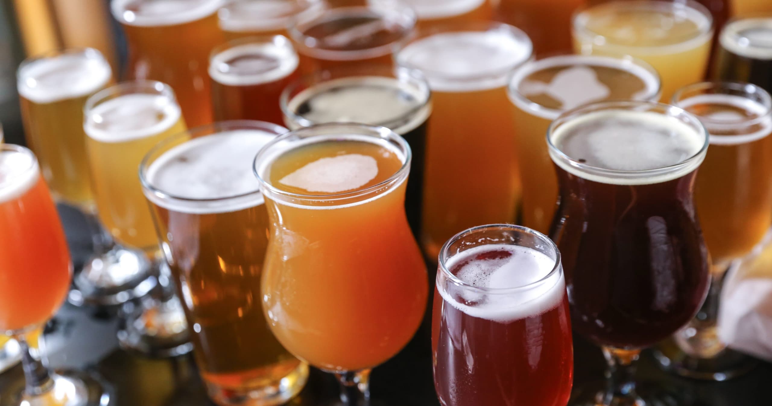 Assorted craft beers on tasting flight at a brewery bar
