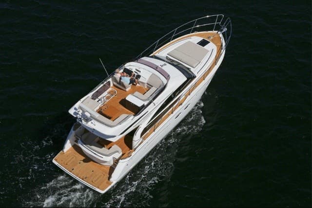 Aerial top-down luxury yacht cruising calm dark ocean