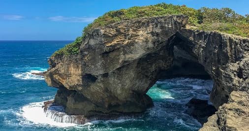 Scenic coastal sea arch on rugged shoreline, Puerto Rico
