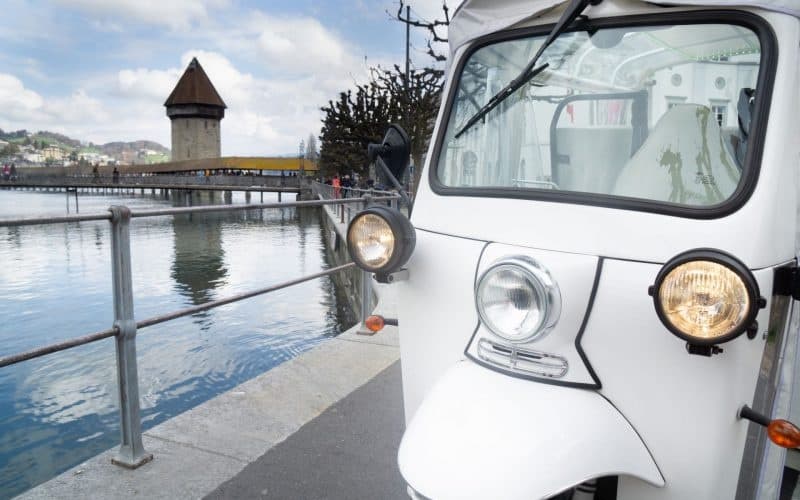 Tuk-tuk tour on Lucerne waterfront with Chapel Bridge view