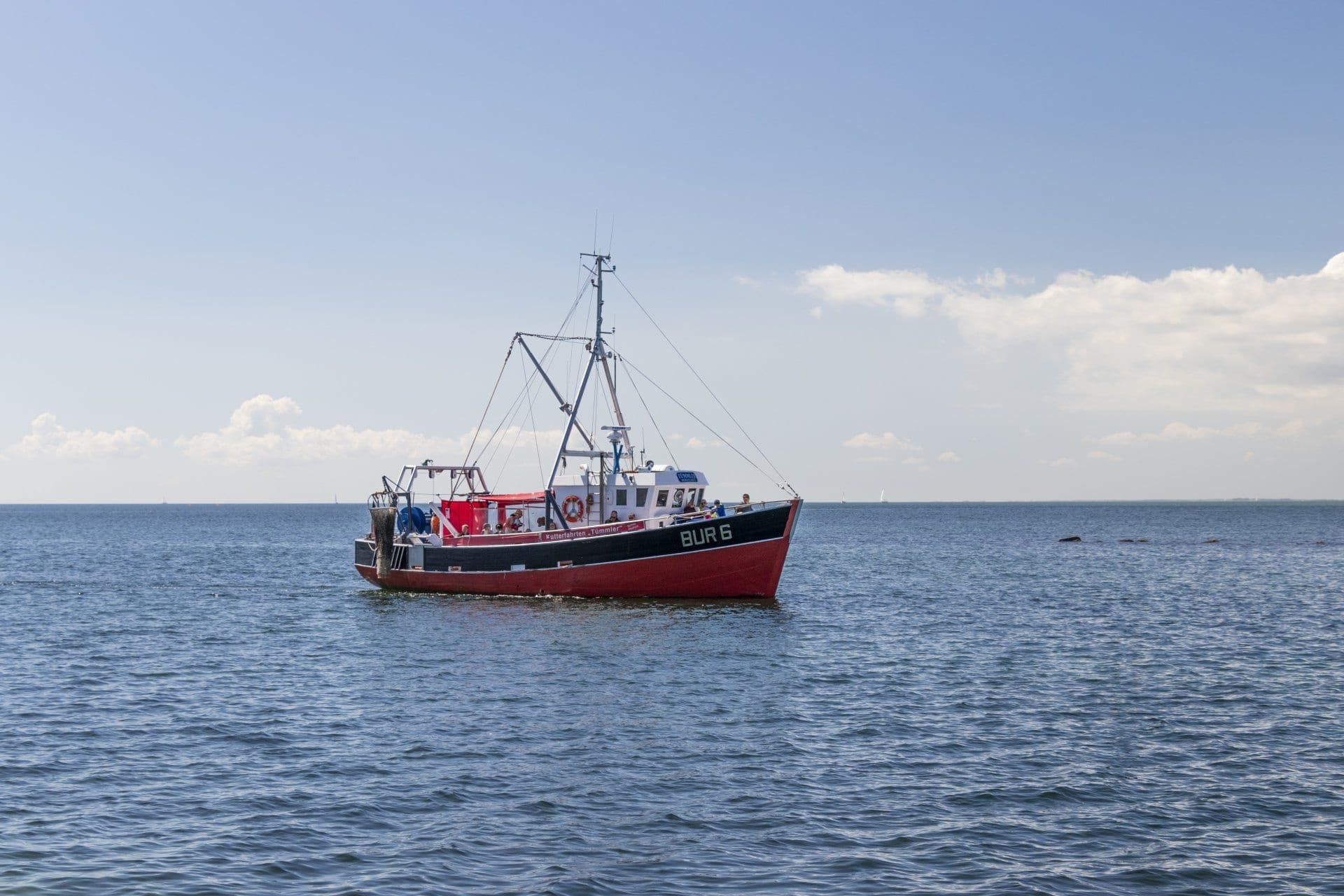 Red fishing boat off Fehmarn island Baltic Sea, coastal fishing trip